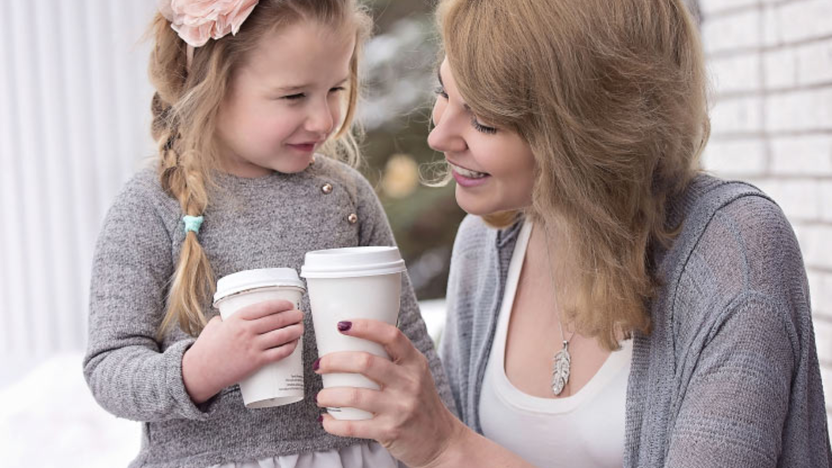 Mother and Daughter Holding Takeout Cups