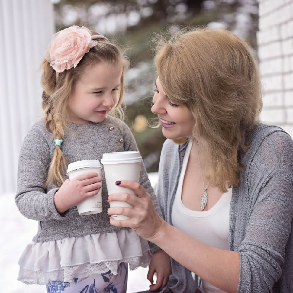 Mother and Daughter Holding Takeout Cups